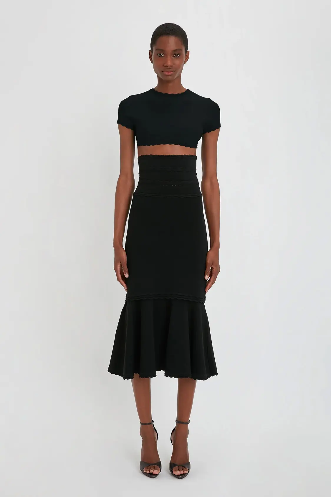VictoriaBeckham_FlaredSkirtInBlack_BLACK_1223KSK004554A_2700_4050_247_WHITE_LR_HR_Front_Model1_JPG2_1500x Flared Midi Skirt In Black - Image 1